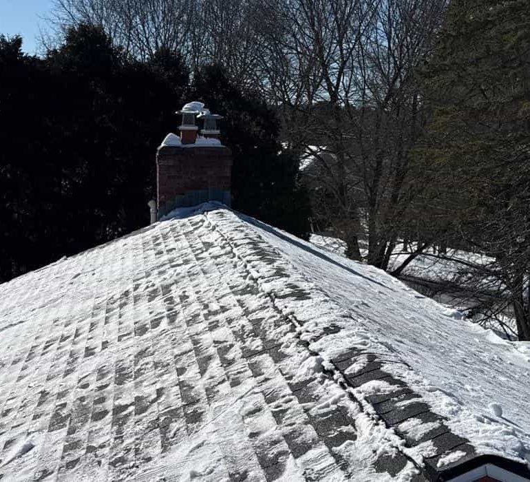 roofing repair replacement inspection guide Roof repair and inspection work in progress with snow removal from asphalt shingle roof during winter season