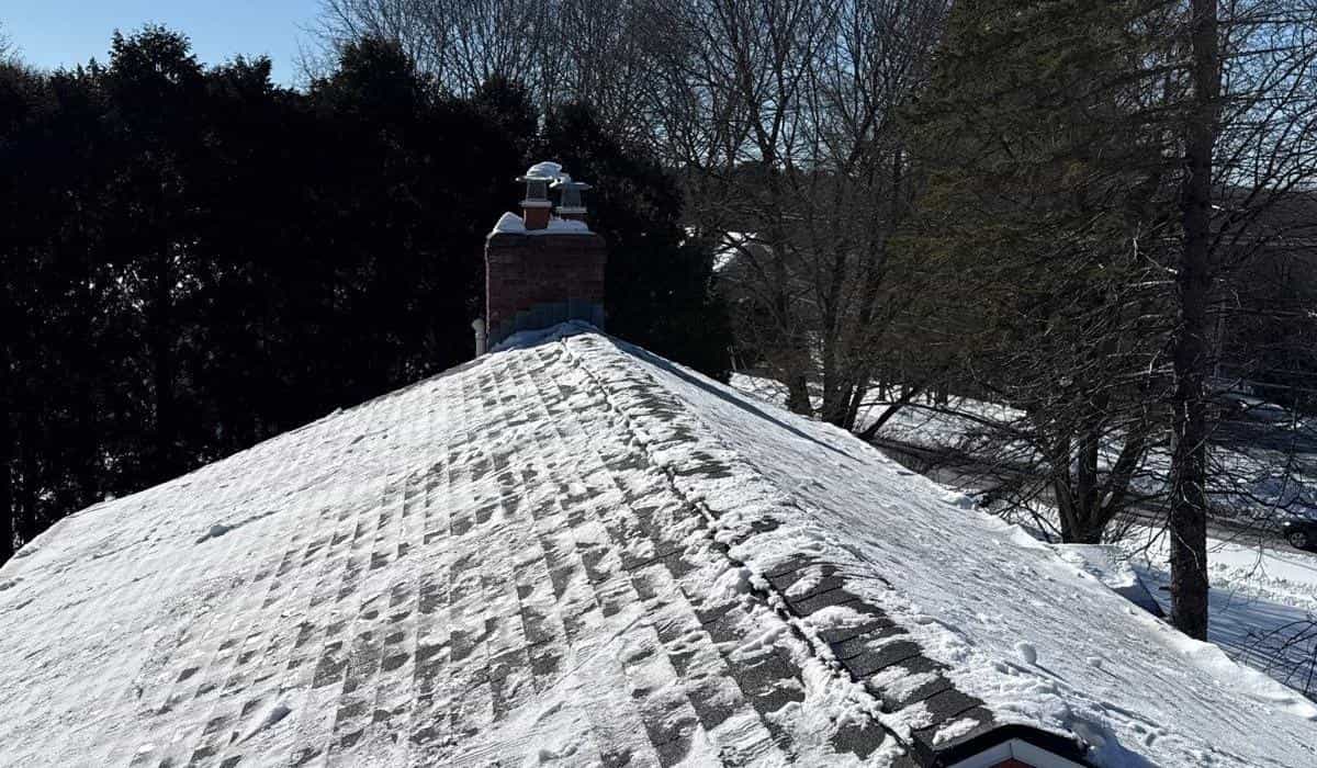 roofing repair replacement inspection guide Roof repair and inspection work in progress with snow removal from asphalt shingle roof during winter season