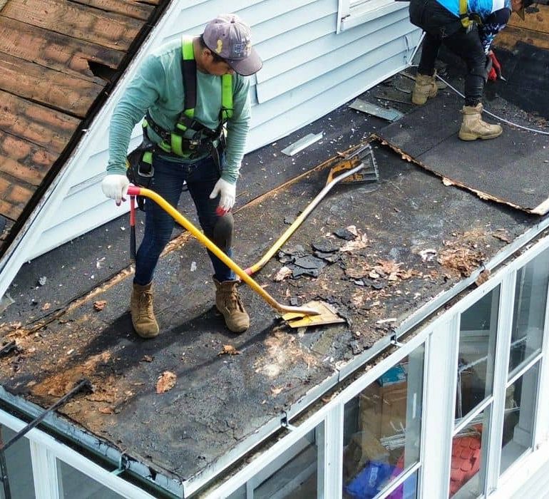 roof replacement cost what homeowners should expect Professional roof replacement in progress with contractors removing old shingles on a residential home